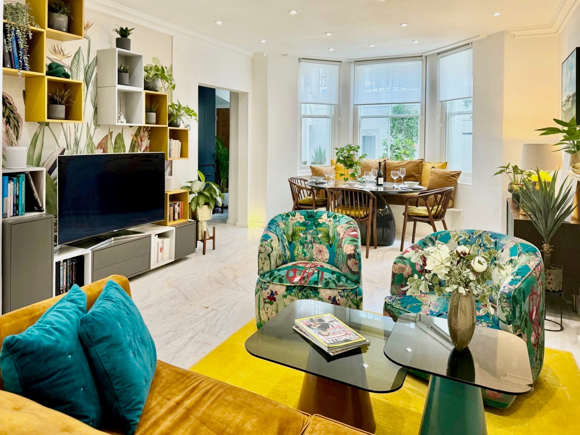 Living room with velvet sofa, art and natural light from the back garden, South Kensington